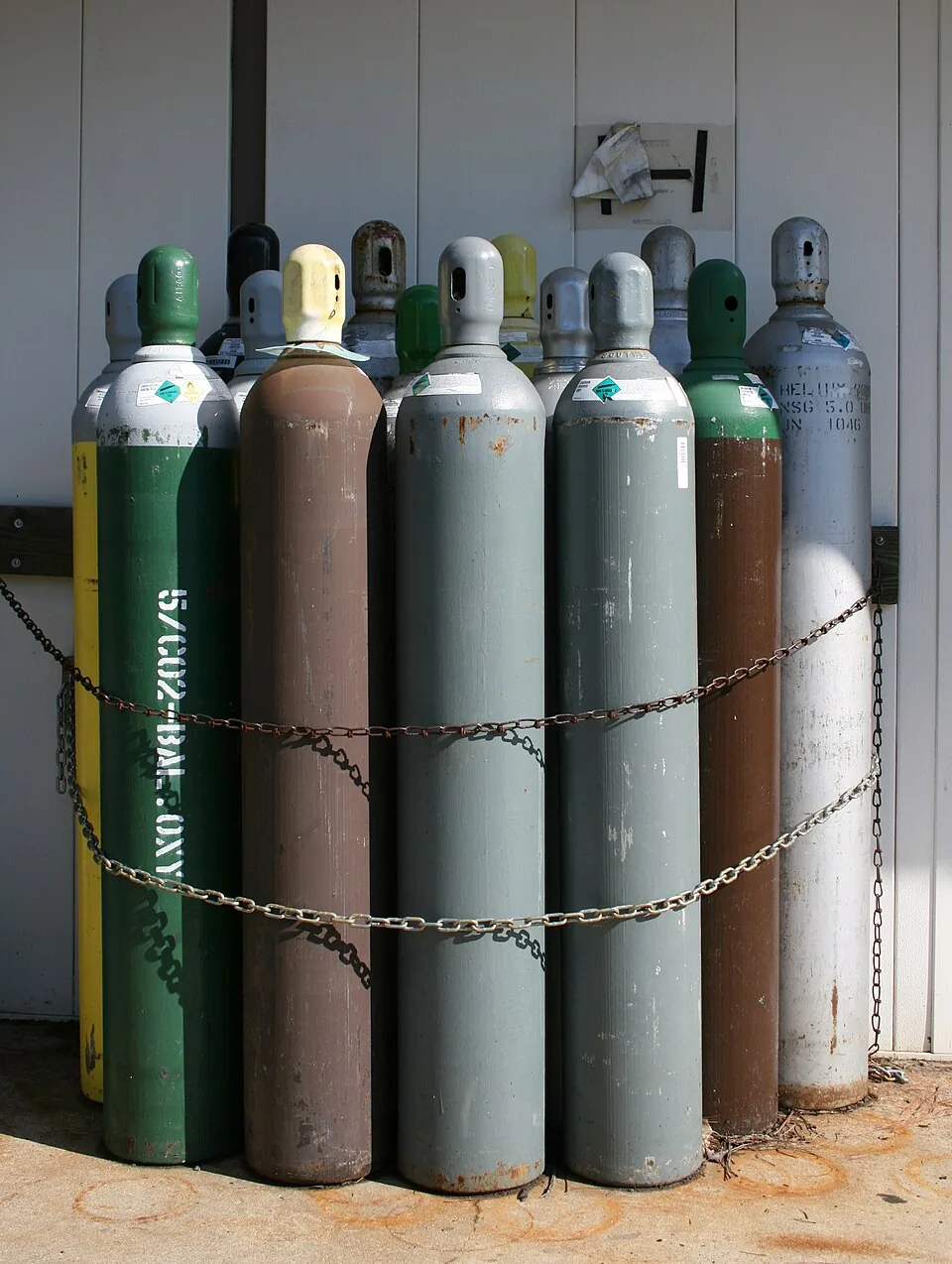 A row of industrial gas cylinders stored together