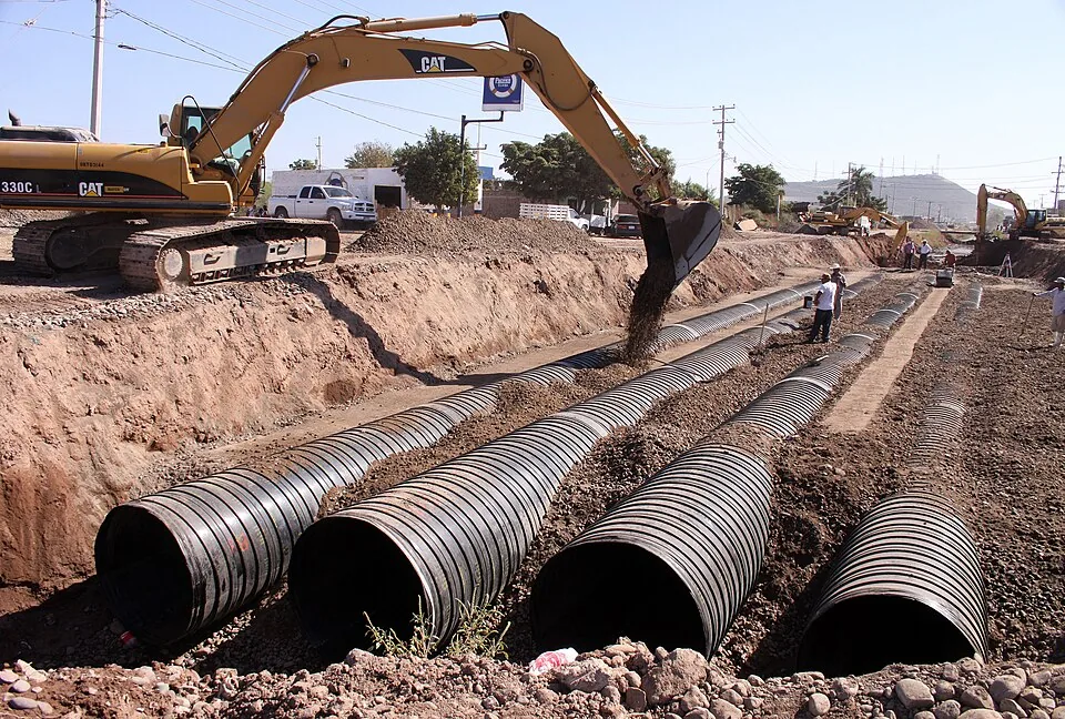 Large steel pipes staged for installation